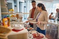 Young business people are enjoying in self service of delicious food at the canteen. Business, people, company Royalty Free Stock Photo