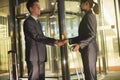 Young business people handshaking outside of the office Royalty Free Stock Photo