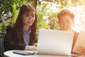 young business people having a meeting. businessman & businesswoman working with computer at cafe. startup man & freelance woman Royalty Free Stock Photo