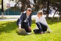Young business people using laptop in city park Royalty Free Stock Photo