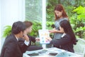 Young business people making meeting and talking for analyzing marketing with graph working at office Royalty Free Stock Photo