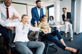 young business people office taking abreak humor pushing chairs Royalty Free Stock Photo