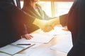 Young business people shaking hands in the office. Finishing successful meeting. Business executives to congratulate the joint Royalty Free Stock Photo