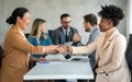Young business people shaking hands in office. Handshake, finishing successful meeting. Royalty Free Stock Photo