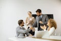 Group of young business people making a deal at a meeting in the office Royalty Free Stock Photo