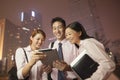 Young business people smiling and working outdoors at night Royalty Free Stock Photo