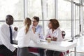 Young business people talking over coffee in a modern lobby