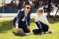 Young business people using laptop in city park Royalty Free Stock Photo