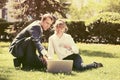 Young business people using laptop in city park Royalty Free Stock Photo