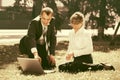 Young business people using laptop in city park Royalty Free Stock Photo