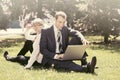 Young business people using laptop in city park Royalty Free Stock Photo