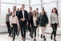 Young business people walking together in a new office Royalty Free Stock Photo
