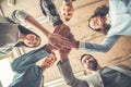 Startupers working at office together standing holding hands bottom view close-up laughing joyful support Royalty Free Stock Photo