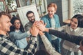 Startupers working at office together standing giving high five top view happy Royalty Free Stock Photo