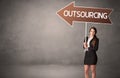 Young business person in casual holding road sign Royalty Free Stock Photo