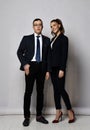 Young business professionals man and woman coworkers in official suits standing. Full growth portrait. Royalty Free Stock Photo