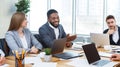 Young business team analysing graphs and charts at meeting Royalty Free Stock Photo