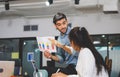 Young business team of coworkers meeting in creative office, businessman holding paper and sitting on table, Teamwork concept Royalty Free Stock Photo