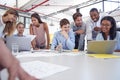 Young business team gathered around two laptops in an office Royalty Free Stock Photo