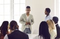 Young business team manager talking to his diverse employees during a work meeting