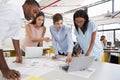 Young business team work standing at desk in a busy office Royalty Free Stock Photo