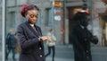 Young business woman african american girl lady walking near building of company office being late for interview meeting Royalty Free Stock Photo