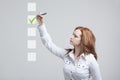 Young business woman checking on checklist box. Gray background. Royalty Free Stock Photo