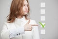 Young business woman checking on checklist box. Gray background. Royalty Free Stock Photo