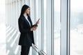 Young business woman checking email or text message from smartphone and take break to drink coffee while stand at office workplace Royalty Free Stock Photo