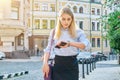 Young business woman in city looking at her wristwatch Royalty Free Stock Photo