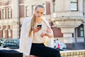 Young business woman in city looking at her wristwatch Royalty Free Stock Photo