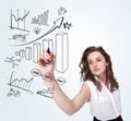 Young business woman drawing diagrams on whiteboard Royalty Free Stock Photo