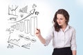 Young business woman drawing diagrams on whiteboard Royalty Free Stock Photo