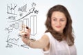 Young business woman drawing diagrams on whiteboard Royalty Free Stock Photo