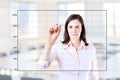 Young business woman drawing on empty graph.