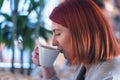 Young business woman drinking coffe and thinking about new projects at brake in a coffee bar Royalty Free Stock Photo