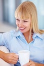 Young business woman drinking coffee. Closeup of young business woman with coffee cup looking away. Royalty Free Stock Photo