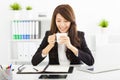 Young business woman drinking coffee in office Royalty Free Stock Photo