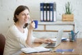 Young business woman drinking coffee at workplace Royalty Free Stock Photo