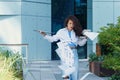 Young business woman dropping paper documents on the floor. Occasion near office building.