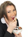 Young Business Woman Eating a Bowl of Cereals with Yogurt and Be Royalty Free Stock Photo