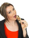 Young Business Woman Eating a Breakfast Cereal Bar Royalty Free Stock Photo