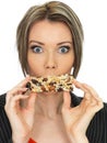 Young Business Woman Eating a Breakfast Cereal Bar Royalty Free Stock Photo