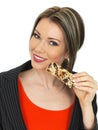 Young Business Woman Eating a Breakfast Cereal Bar Royalty Free Stock Photo