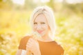 Young business woman with field flowers in hands outside after Royalty Free Stock Photo