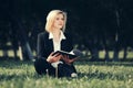 Young business woman with a folder in city park Royalty Free Stock Photo