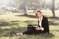 Young business woman with a folder in a city park Royalty Free Stock Photo