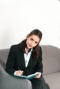 Young business woman freelancer or ceo employee making notes in notebook in office. Royalty Free Stock Photo