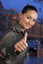 Young business woman give thumbs up