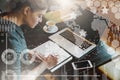 Young business woman in gray dress sitting at table in cafe and writing in notebook. Royalty Free Stock Photo